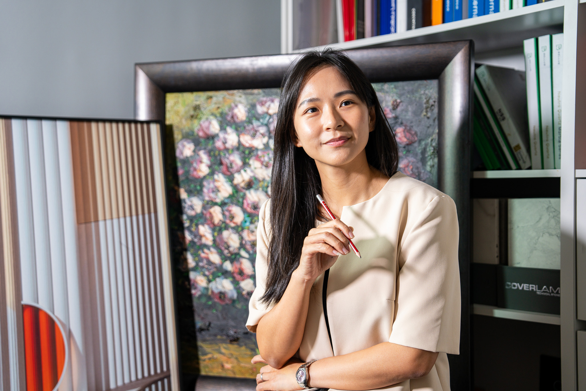 The Dreamer Home designer photographed among showroom material samples