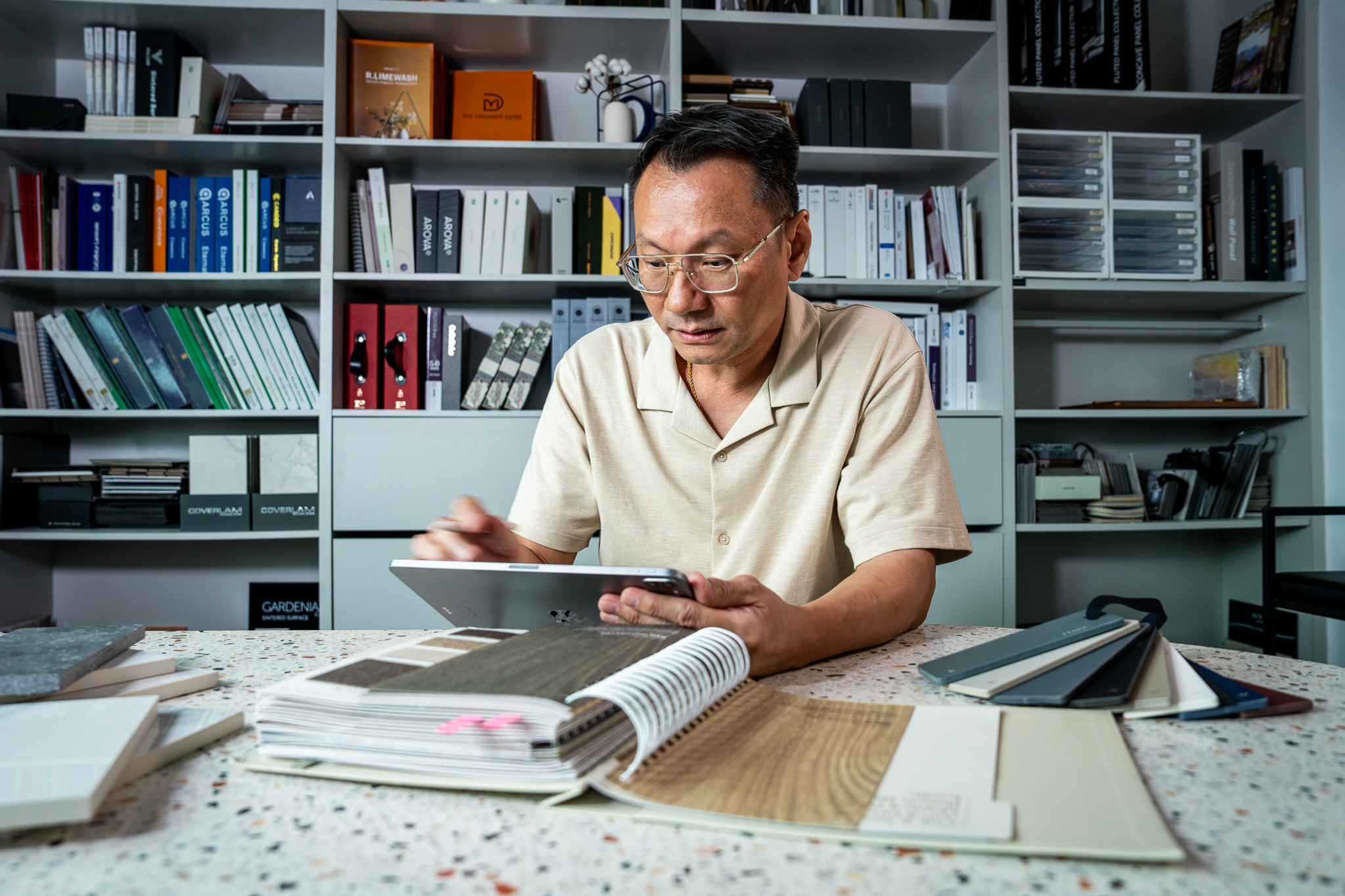 The Dreamer Home founder reviewing finish samples on a tablet