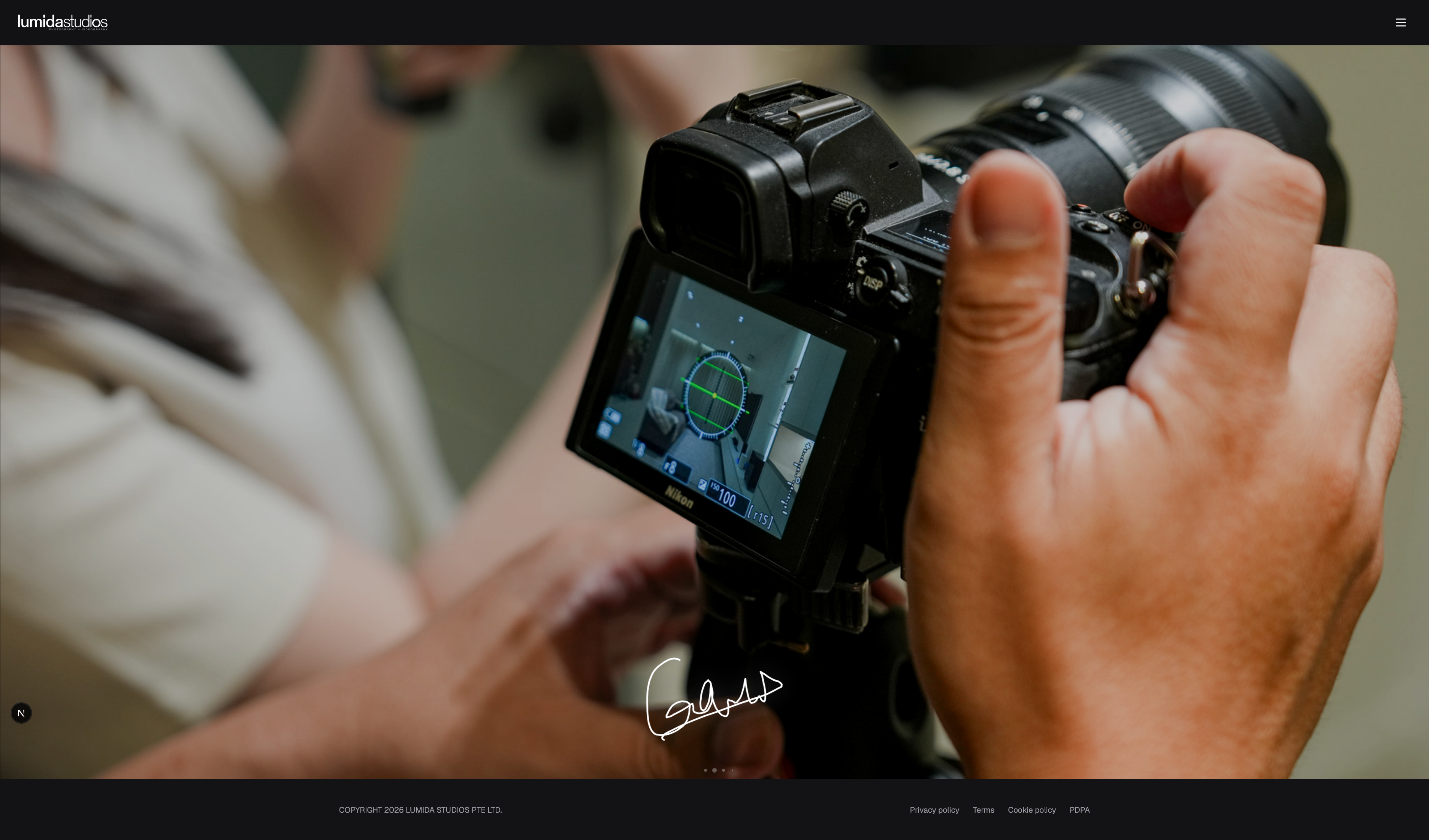 Lumida Studios homepage featuring a close-up of Gavin checking the camera during a property shoot