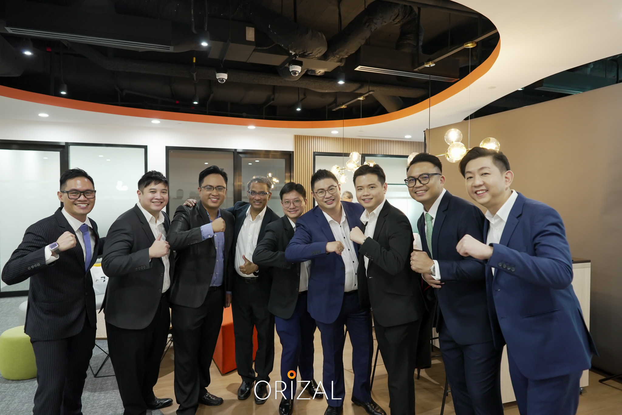 Orizal advisors in suits posing for a group portrait
