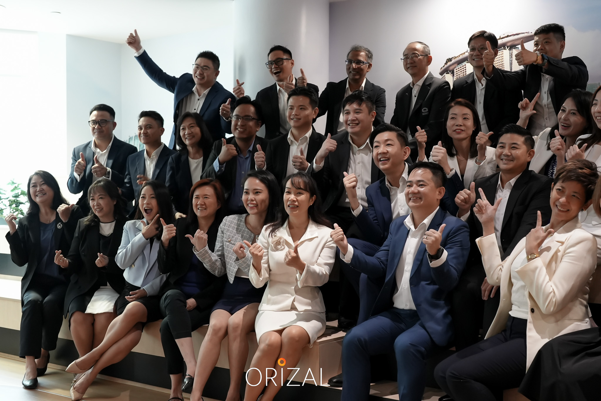 The Orizal team smiling and making celebratory gestures for a group photo