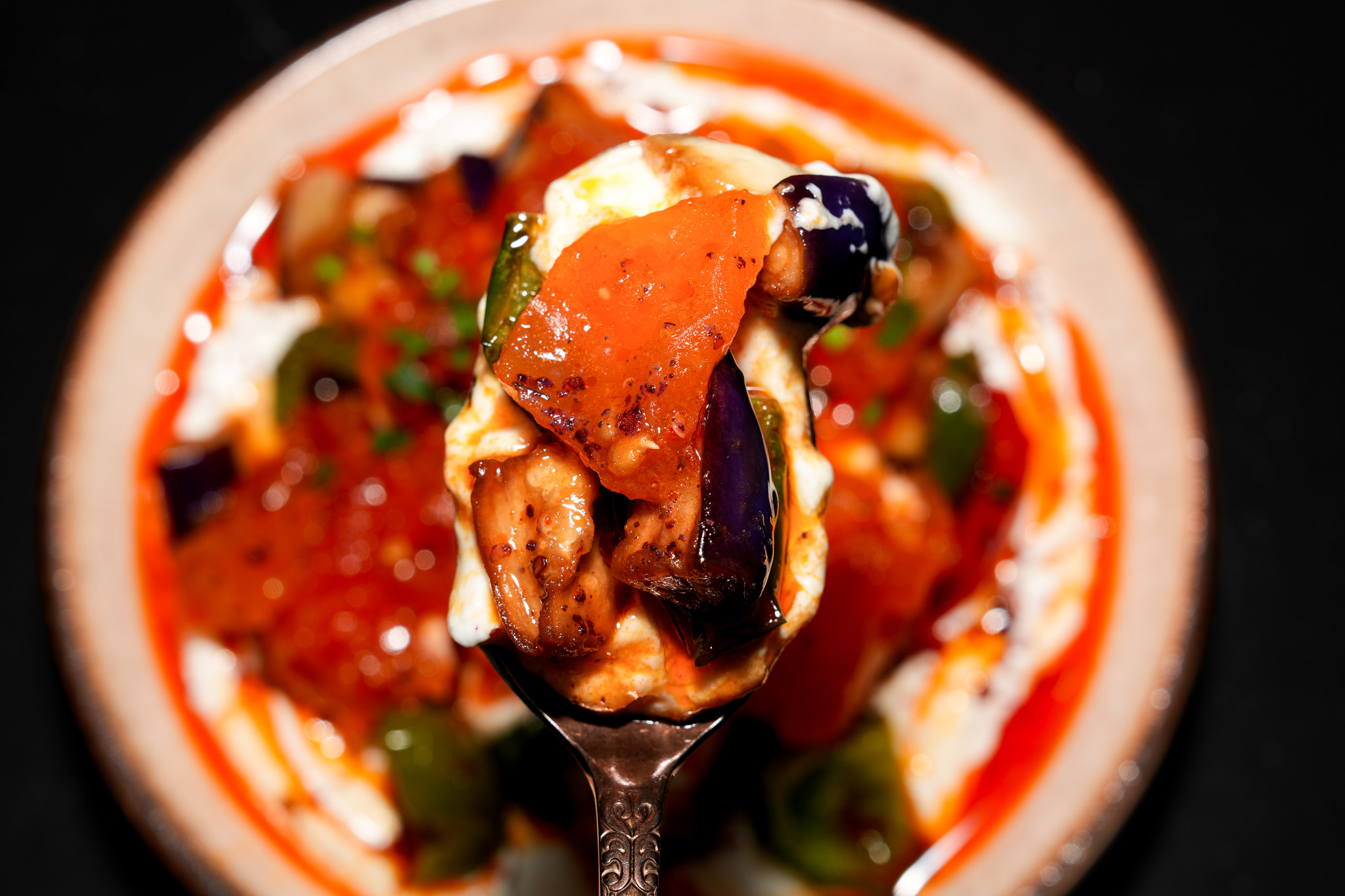 A spoonful of aubergine and tomato sauce
