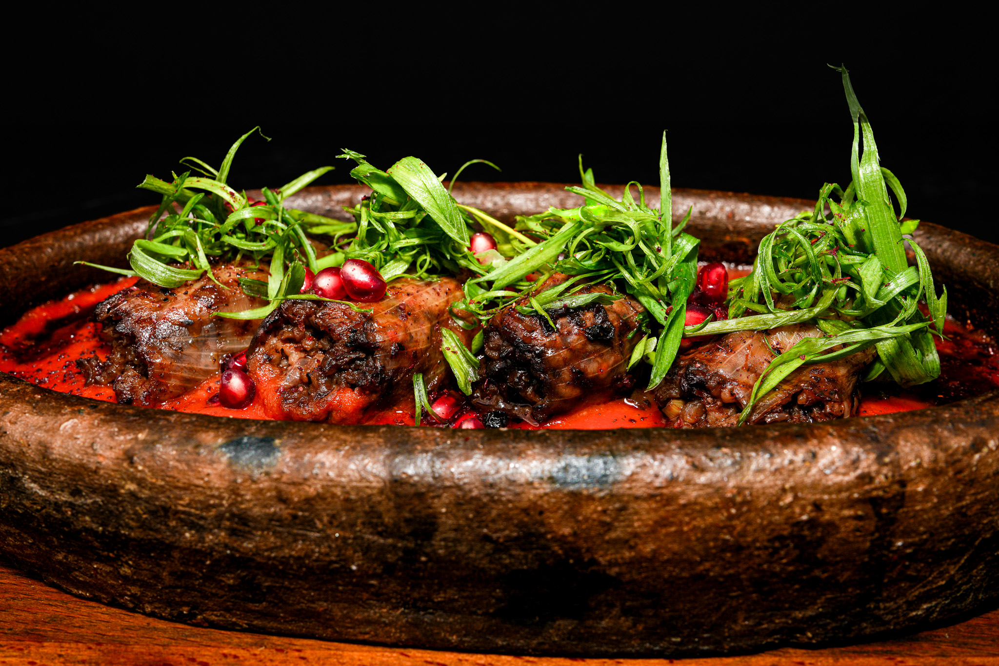 Close-up of meatballs in tomato sauce in a clay dish