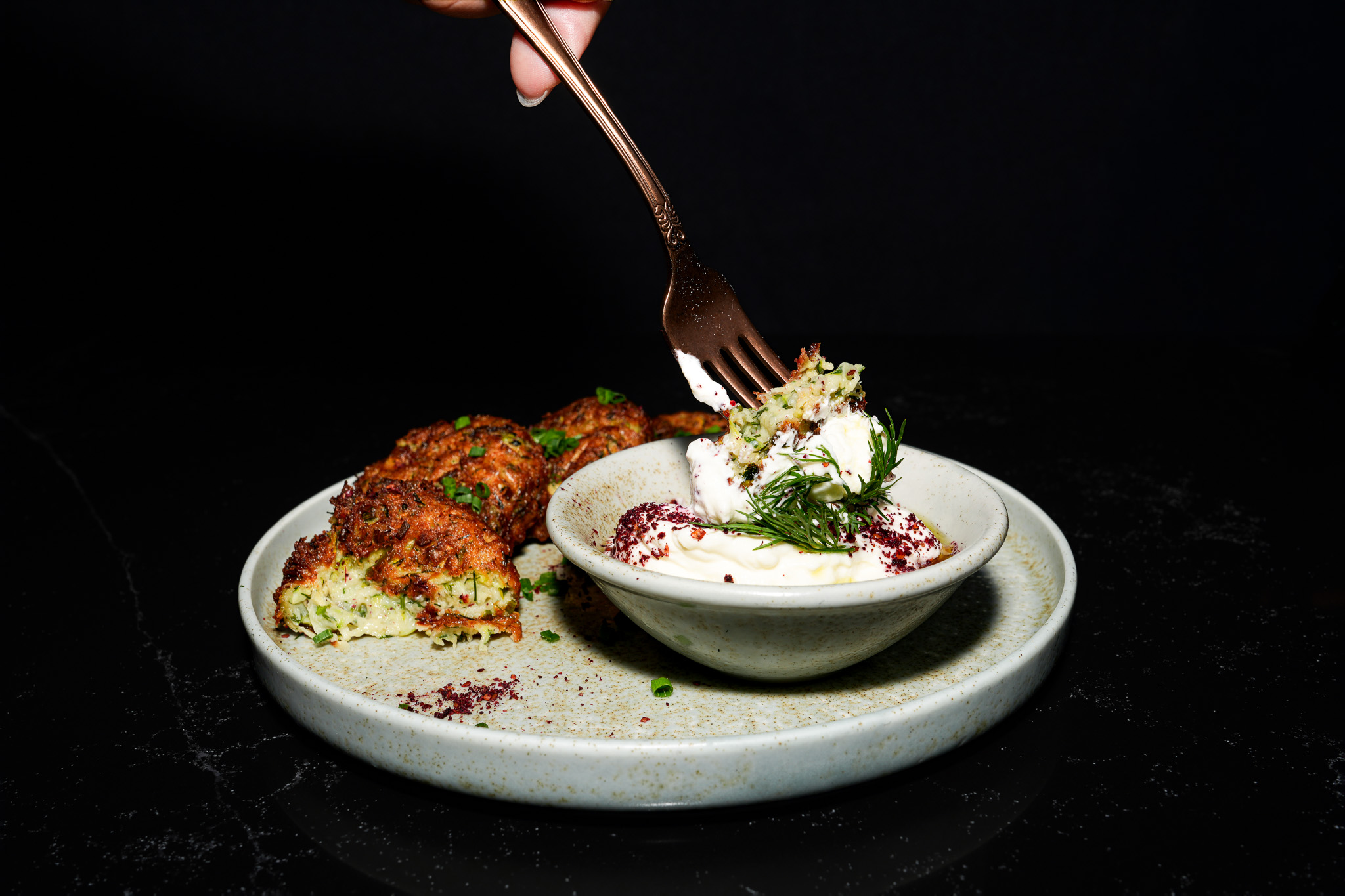 Vegetable fritters served with yogurt dip