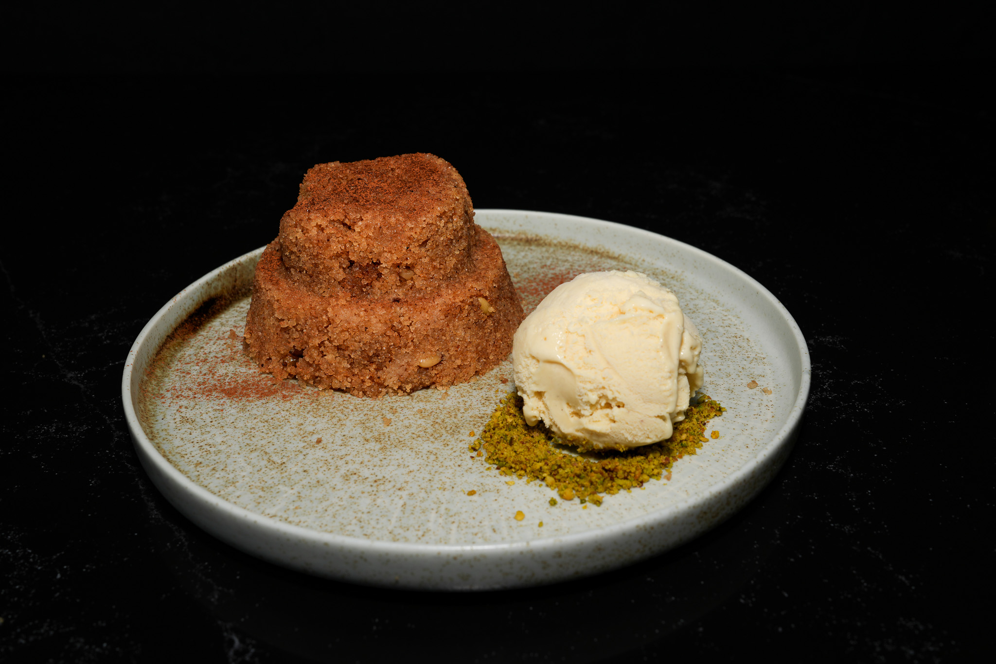 A warm individual dessert served beside a scoop of ice cream